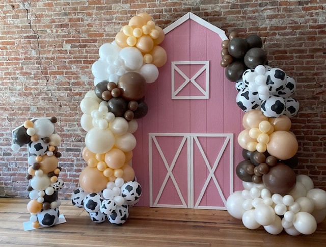 Farm birthday balloon garland with pink barn backdrop